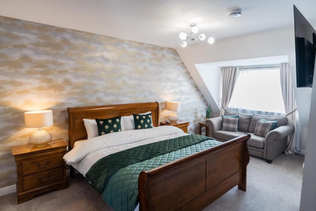 a bedroom with a bed and a chair at Dublin Premier Homestay in Ráth Cúil