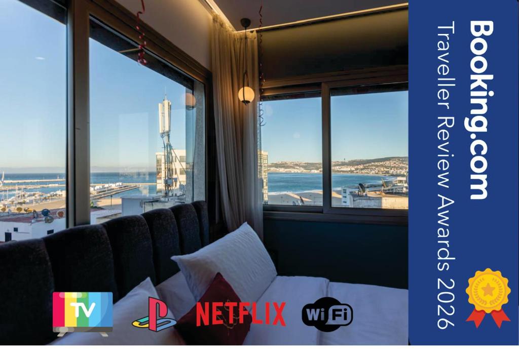 a hotel room with a view of the ocean at Marina View Residence, Luxury Studio, Ocean View, Enjoy Starlink High Speed WiFi, IPTV, PlayStation PS4 Plus, Near TGV, Airport Bus, Taxi, Indrive, and so on in Tangier