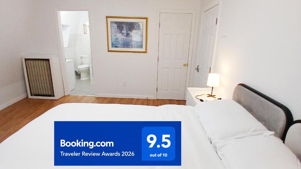 a white bedroom with a bed and a bathroom at King-bed room with private bath -FREE WIFI-- New London-Mystic in New London