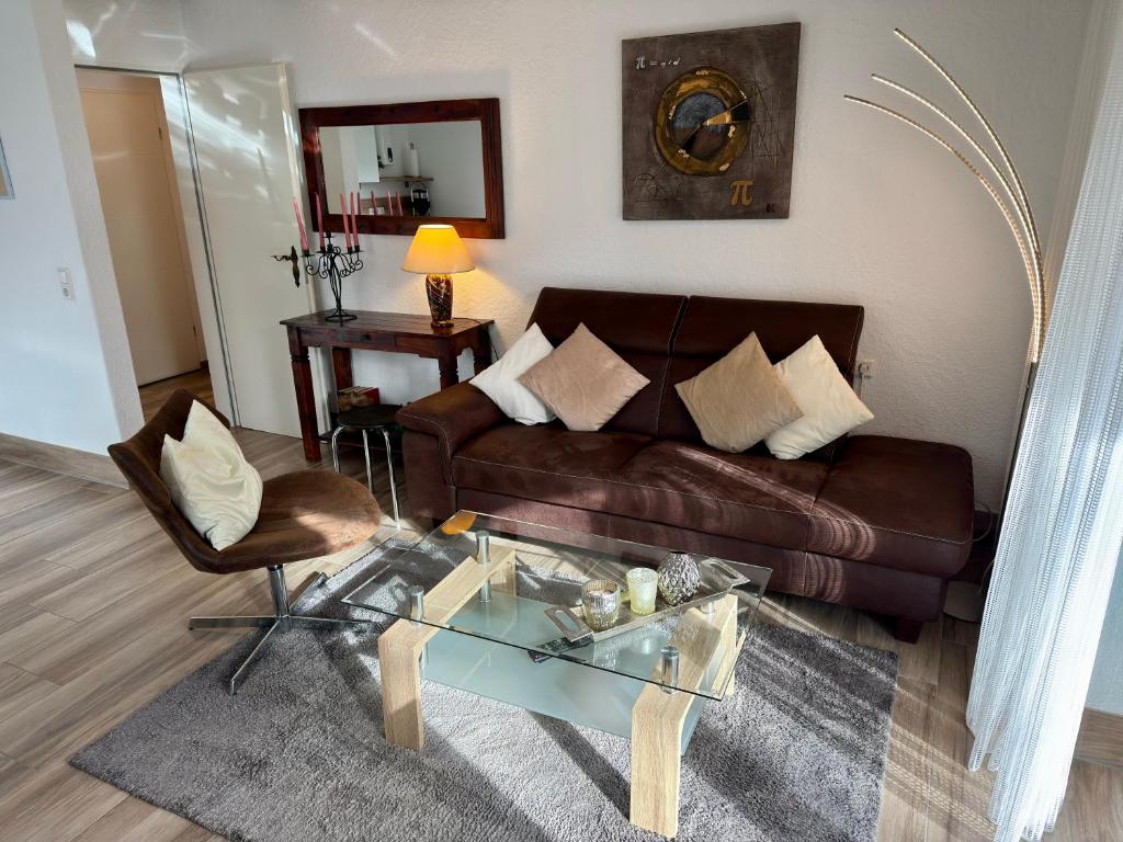 a living room with a couch and a glass table at Haus Edeltrud - Ferienwohnung Moselufer in Bernkastel-Kues