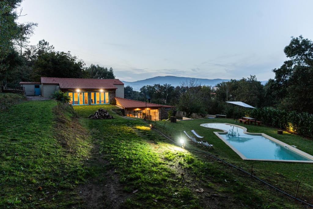 a house on a hill with a swimming pool at Just Like Home - Casa do Botijal in Caminha