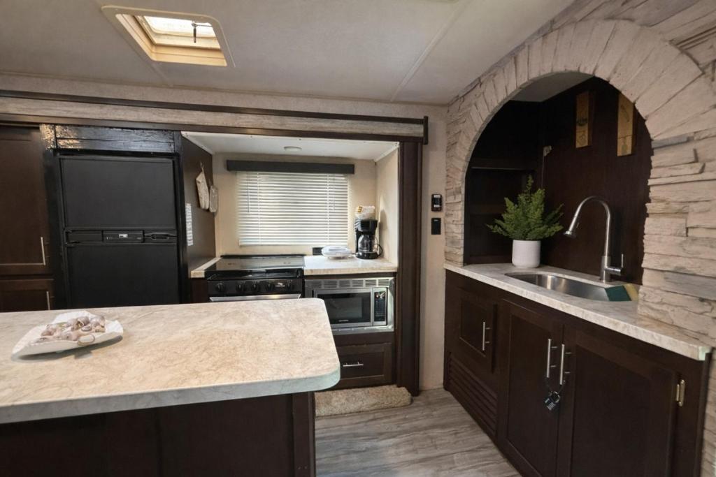 a kitchen with a sink and a counter top at Rincon Camper Retreat in Rincon