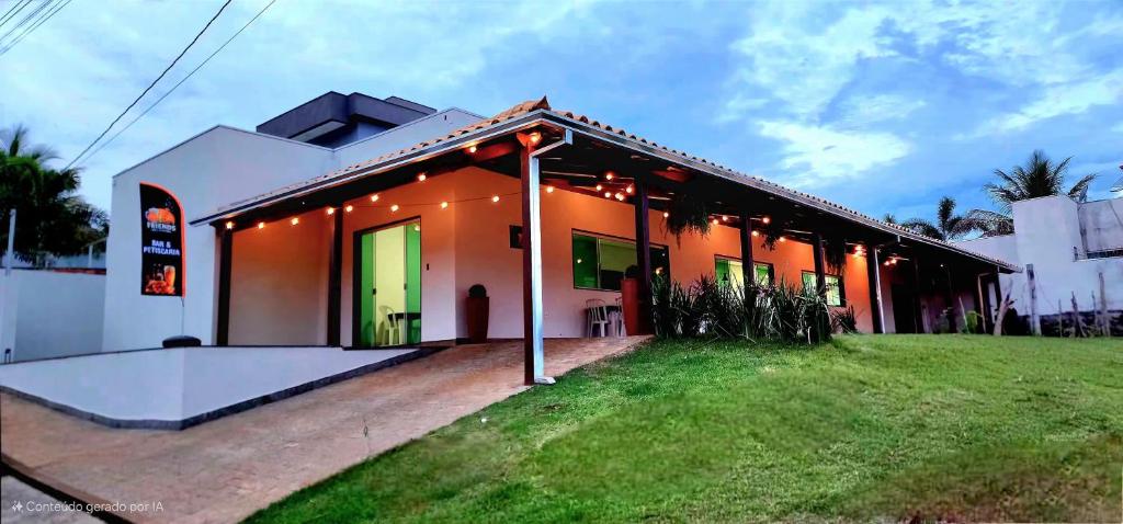 a house with a green lawn in front of it at Pousada In'capitólio in Capitólio