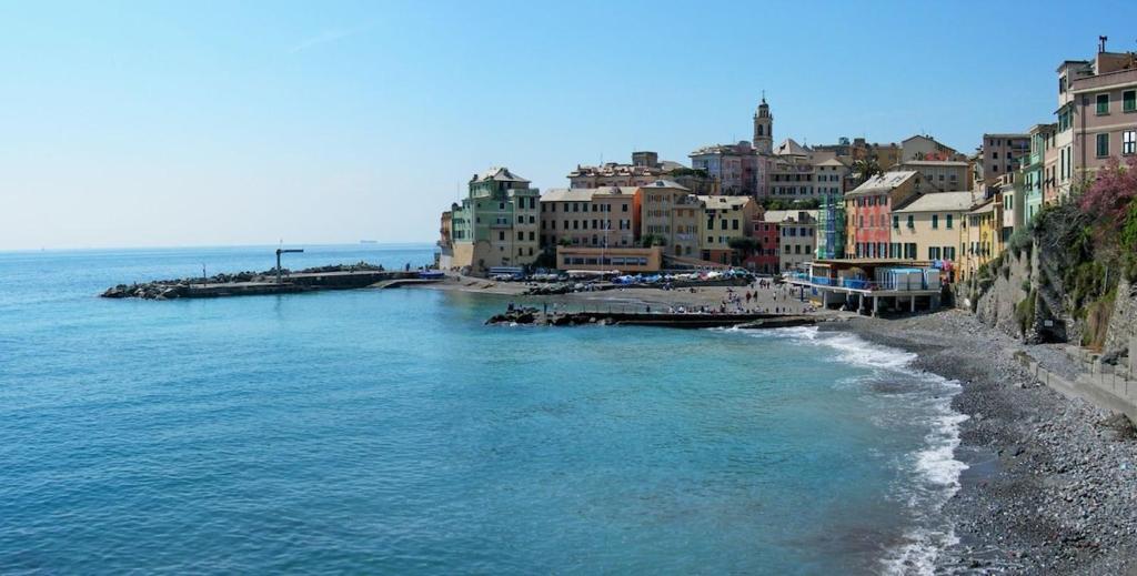 a view of a beach with buildings and the ocean at I ciottoli di Bogliasco in Bogliasco