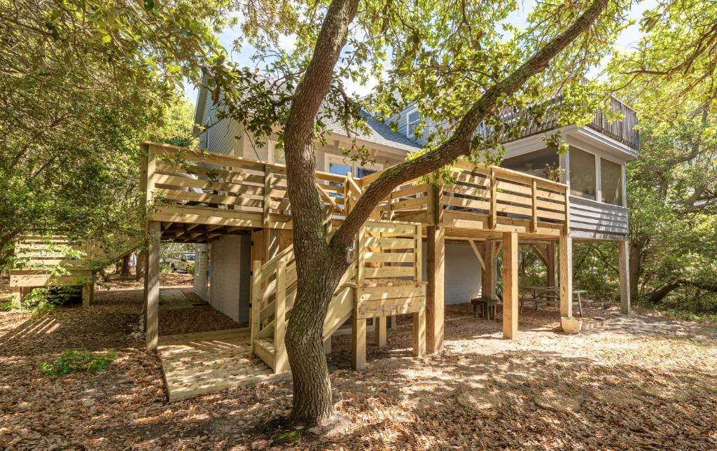 a large house with a tree in front of it at Casa La Playa - Duck, Sanderling, Lakefront, 160 Yards to the Beach, Community Pool, Pets OK in Duck