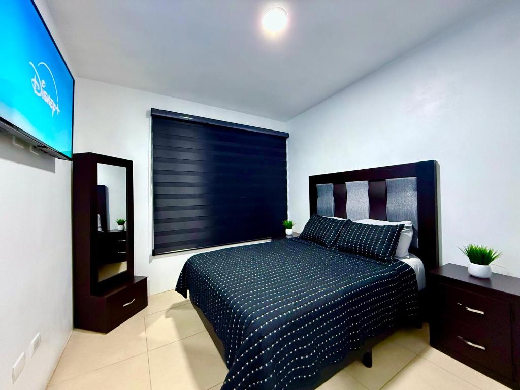 a bedroom with a bed and a large window at Casa Marsella Privada y Moderna 1 in Zaragoza