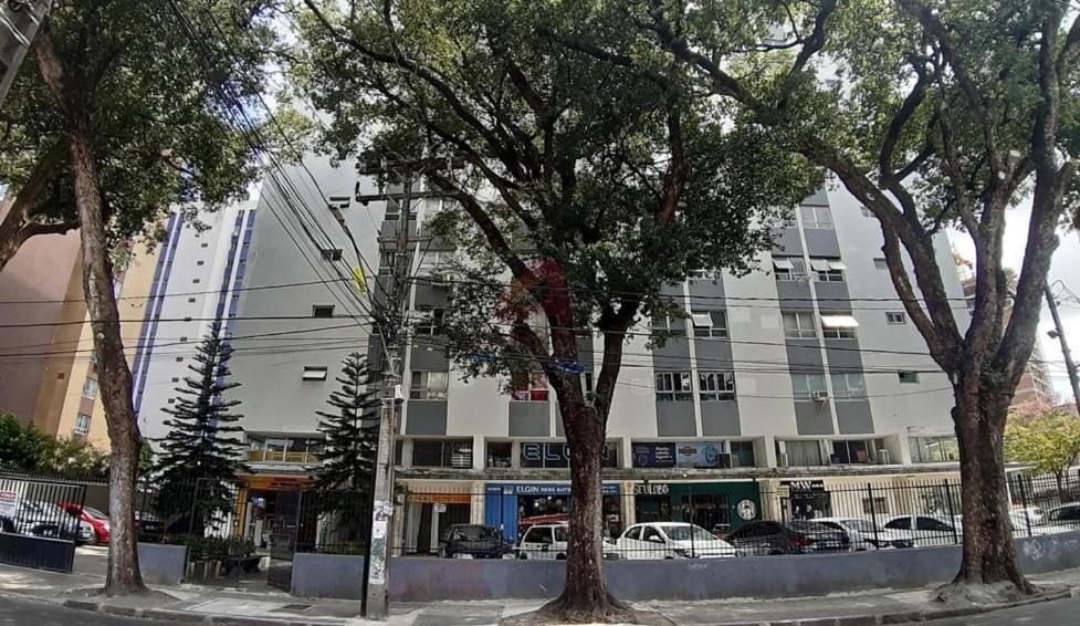 a large building with cars parked in front of it at Izabelly Andrade in Recife