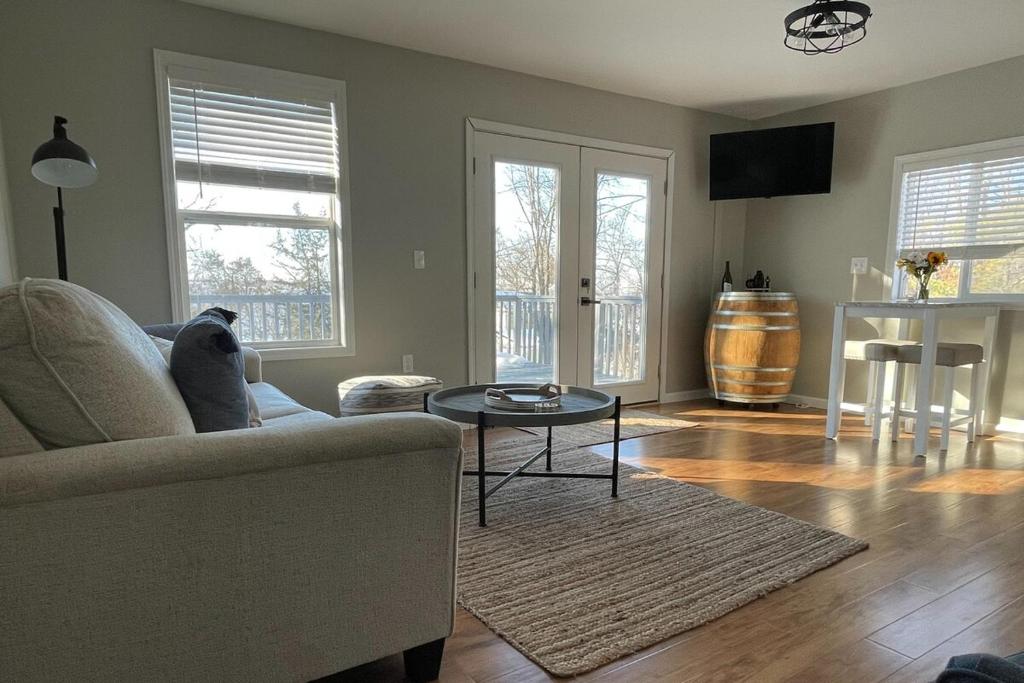 a living room with a couch and a table at Heron Cottage on Cayuga Lake in Aurora