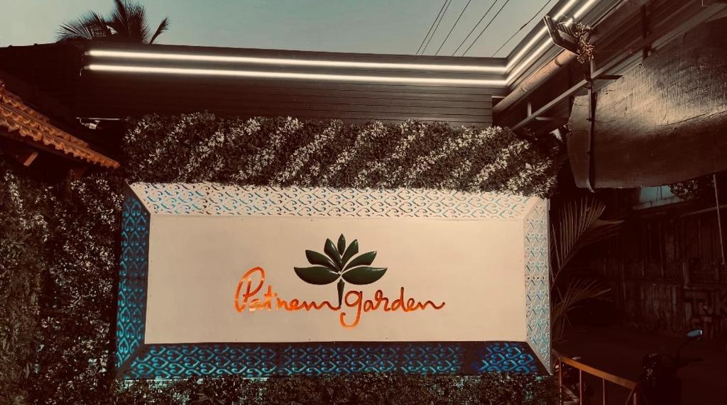a sign on the side of a building at Patnem Garden Resort in Patnem
