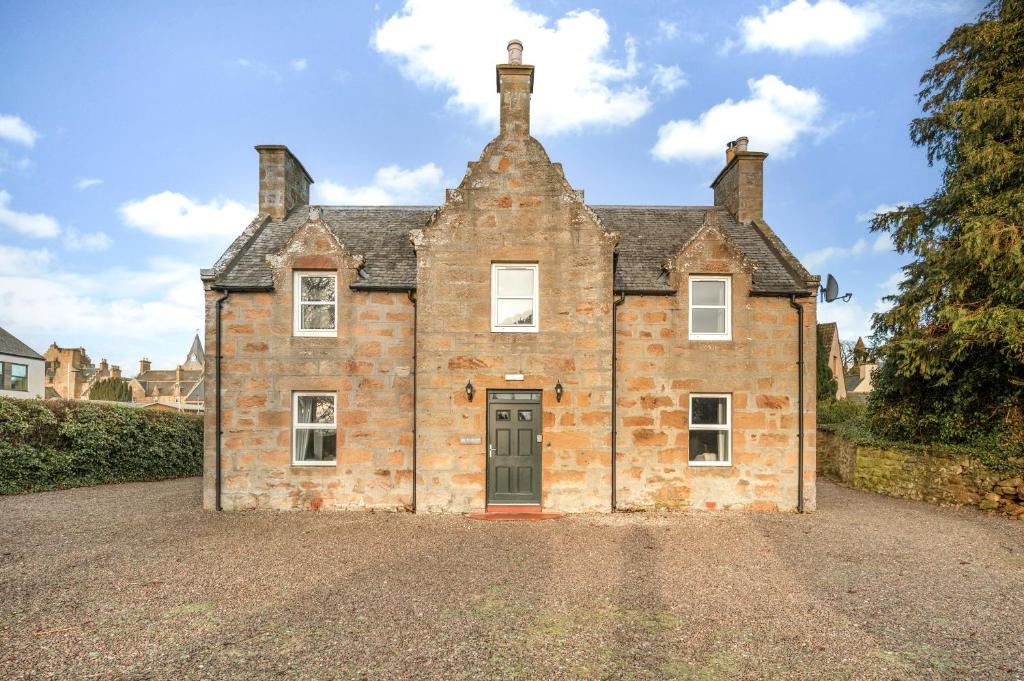 an old brick house with a driveway in front of it at Burnside, Dornoch in Dornoch