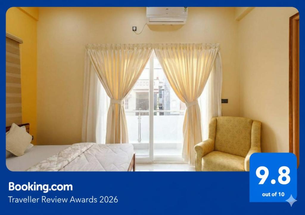 a bedroom with a bed and a window with a chair at Cozy 2BHK Apartment in Vijayanagar Near Attiguppe Metro in Bangalore