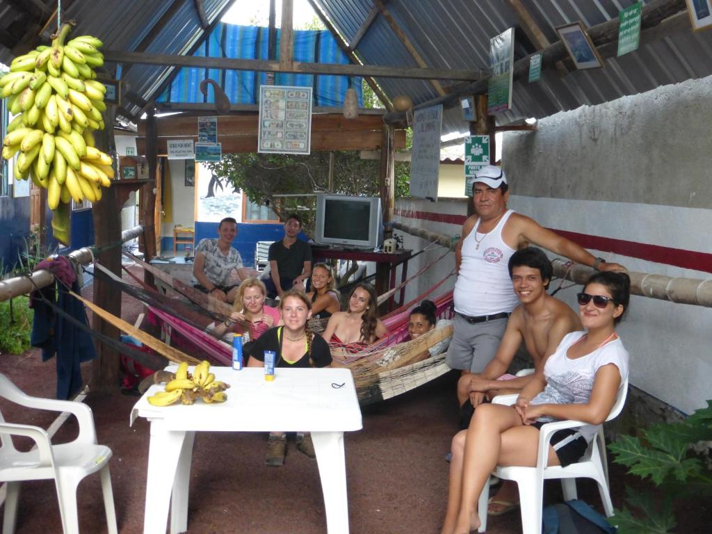 a group of people posing for a picture in a building at Posada del Caminante in Puerto Villamil