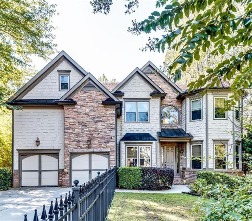 a house with a fence in front of it at 6BD55B,BrookhavenSleeps 12,Big yard,w poolGate in Atlanta