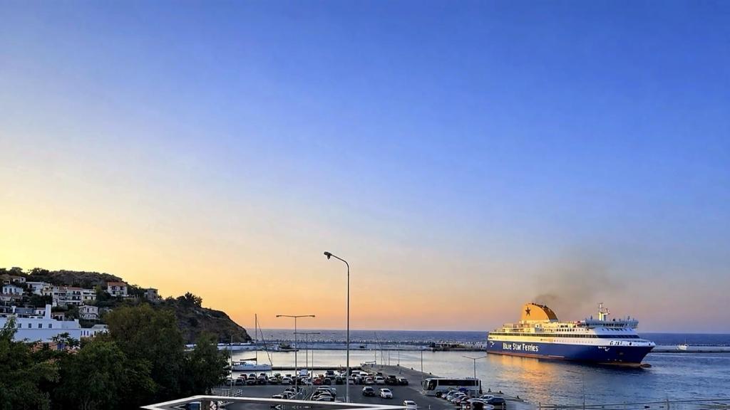 a cruise ship is docked in a harbor at The Icarian resort Dourediko 2 by BRP-PROPERTIES in Evdilos