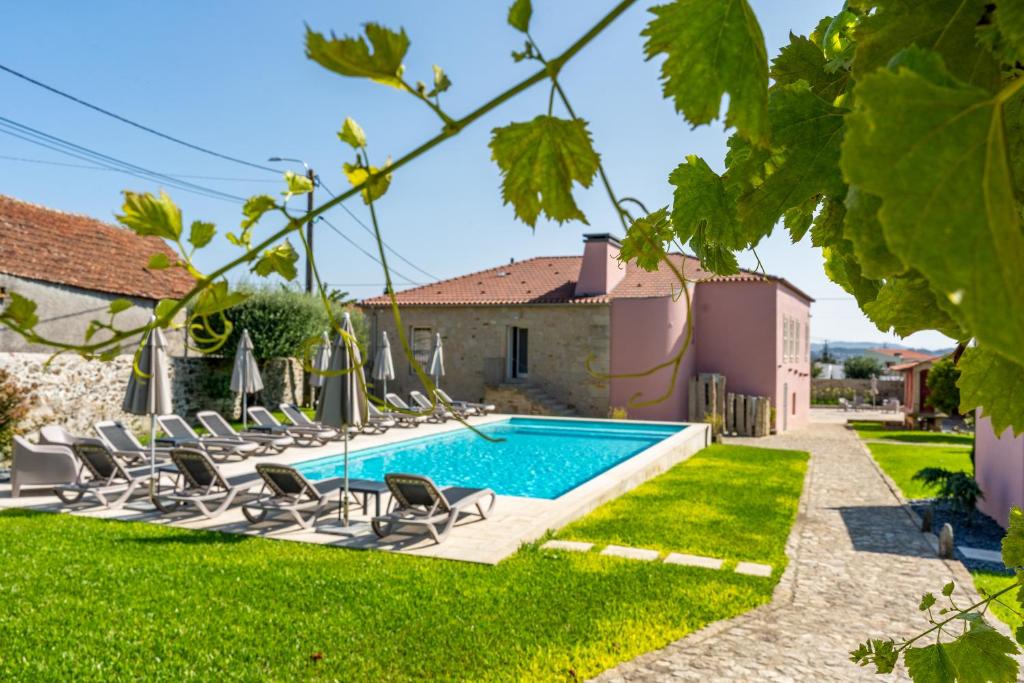 a villa with a swimming pool and lawn at Boutique Hotel Casa da Brêa Viana do Castelo in Viana do Castelo