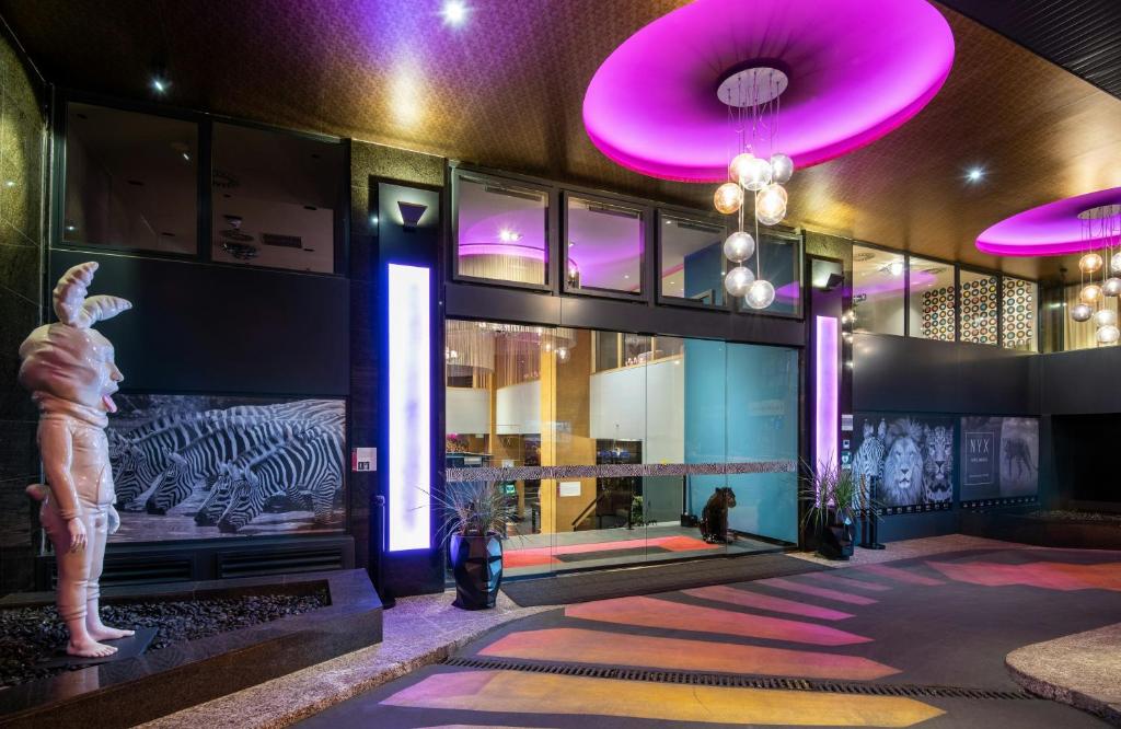 a building with a statue of a zebra and purple lights at NYX Hotel Madrid by Leonardo Hotels in Madrid