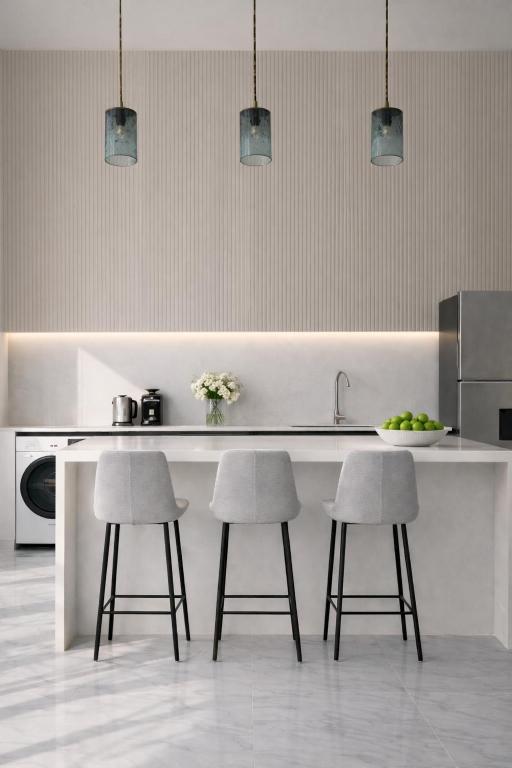 a kitchen with two bar stools and a counter at Nomad Luxe Tulum in Tulum