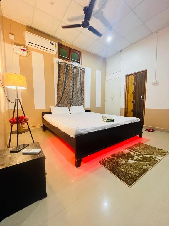 a bedroom with a bed and a lamp in a room at Debox heaven Homestay in Jorhat