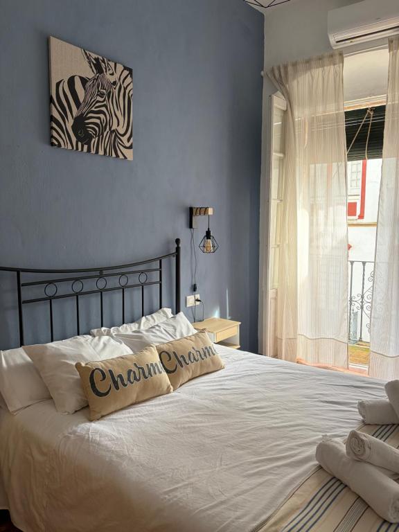 a bedroom with a bed with two pillows on it at El Rincón del Tuno in Carmona