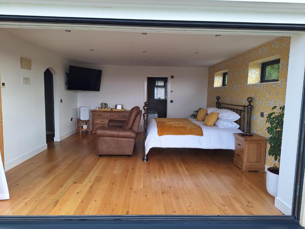a bedroom with a bed and a chair at Room with a View in Glastonbury