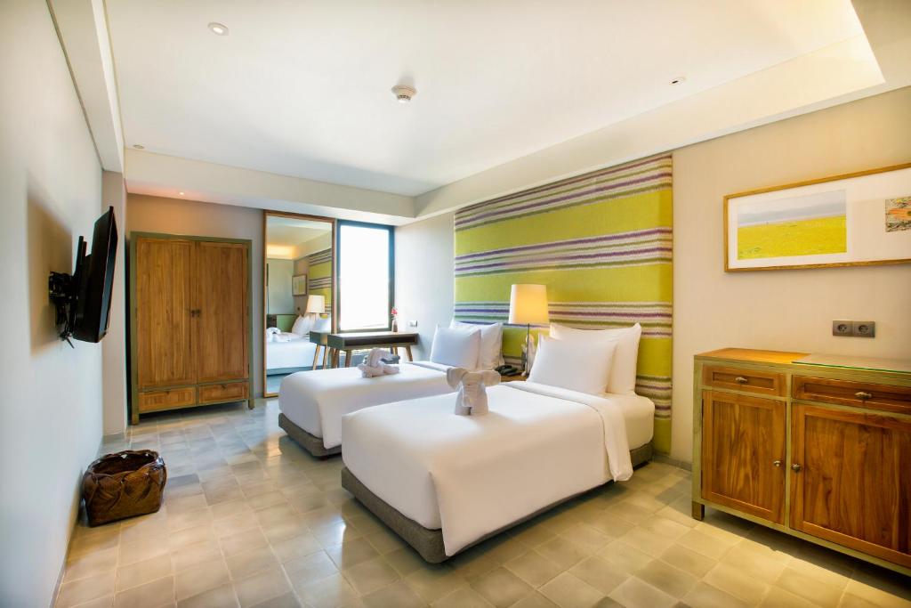 Cama ou camas em um quarto em Tijili Hotel Seminyak