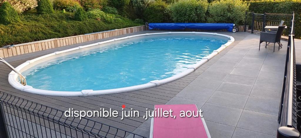 a large swimming pool with a fence around it at Gîte Aux Clochettes à 4km de Francorchamps in Jalhay