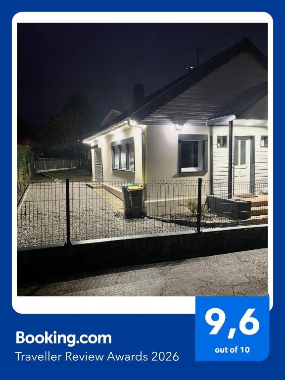 a house with a fence in front of it at night at Maison plain pied a Dieppe in Dieppe