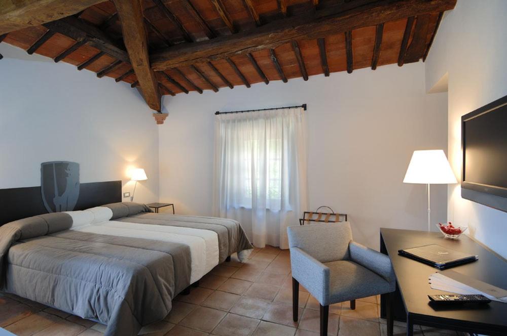 A bed or beds in a room at Locanda Della Picca