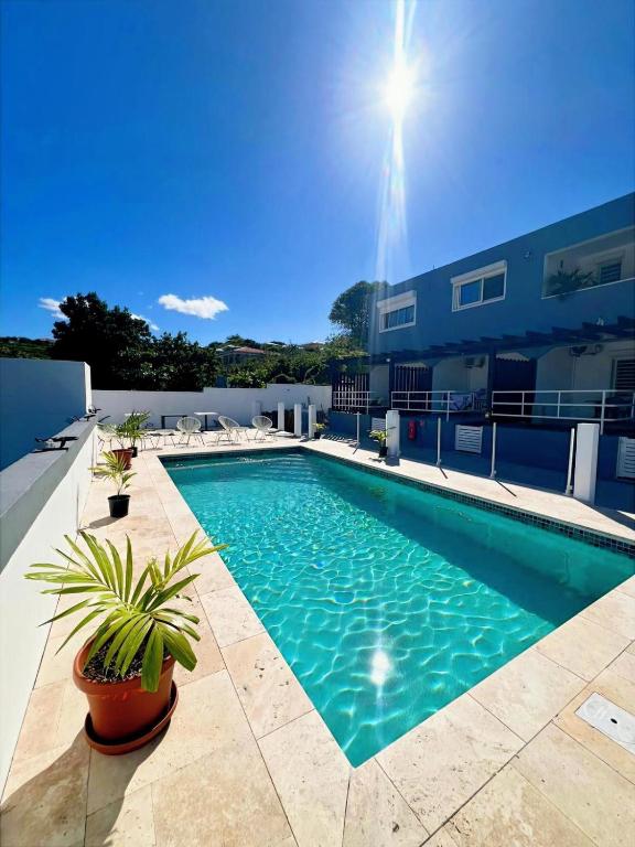 a swimming pool on the roof of a building at Over The Hill Residence - Your Tranquil Oasis in Grand Case