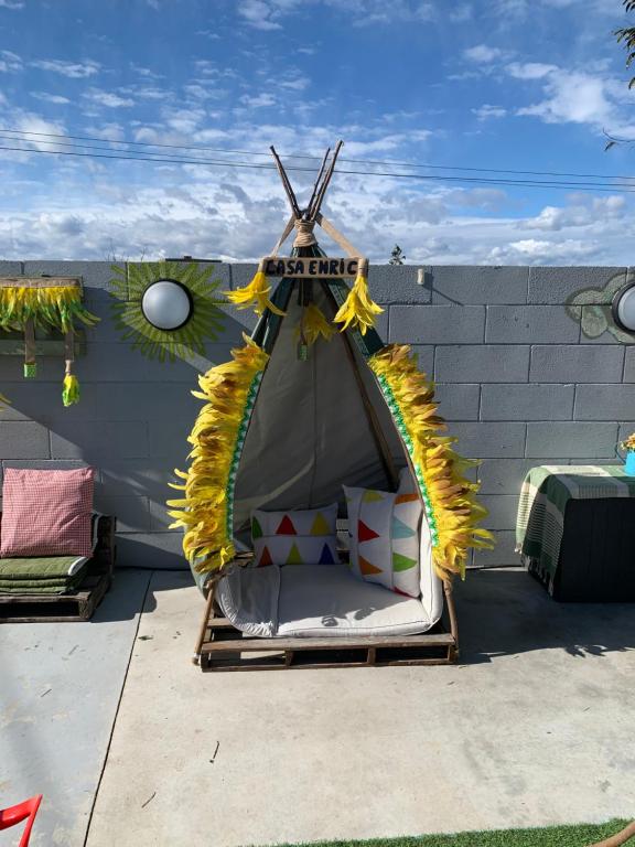 a iguana tent with a bed on a patio at Casa Enric , con zona infantil, piscina y parking privado in Deltebre