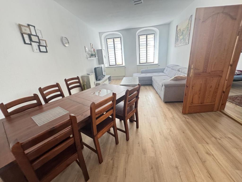 a living room with a table and chairs and a couch at Aaron27 in Meißen