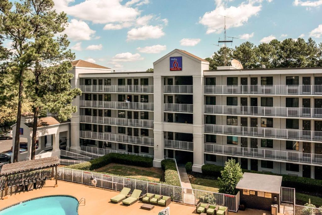 an exterior view of a hotel with a pool at Studio 6-Marietta, GA - Atlanta in Marietta