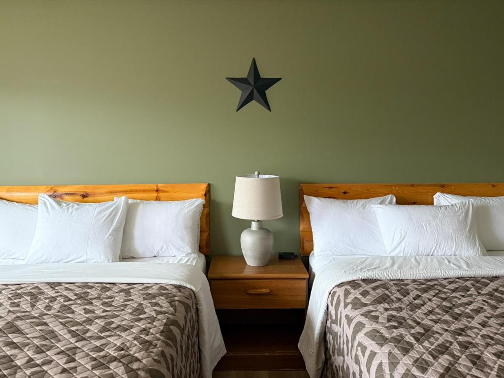 a bedroom with two beds and a star on the wall at The Trail Inn - Grantsburg, WI - 703 WI-70 in Grantsburg