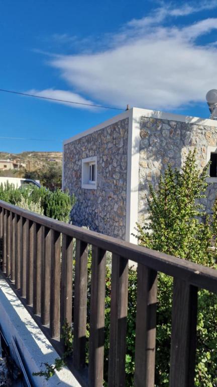 a stone house with a window on a fence at Aelia House Kefalos - Cozy & Quiet in Kos
