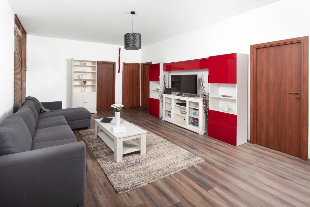 a living room with a gray couch and red cabinets at Zora's apartment in Siófok