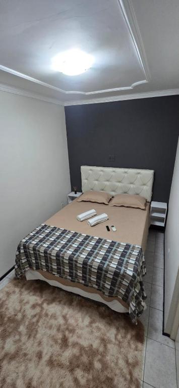a bedroom with a large bed in a room at Tesouro da Maraponga in Fortaleza