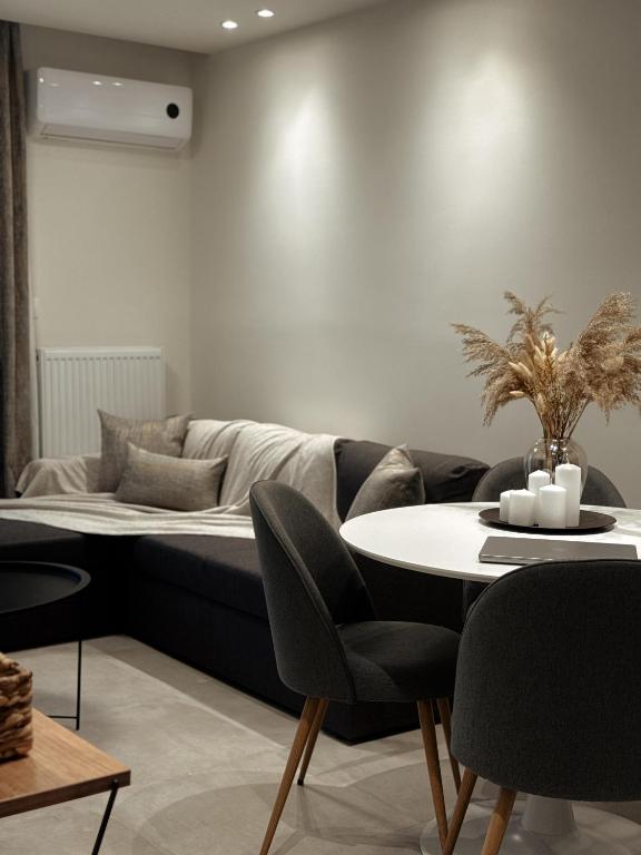 a living room with a couch and a table at AuRa The Golden Suite in Alexandroupoli