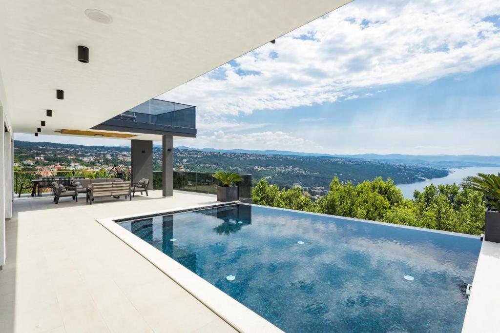 a house with a swimming pool with a view at Villa Titanium in Opatija