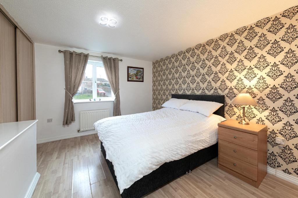 a bedroom with a large bed and a window at Valley View in Shield Row
