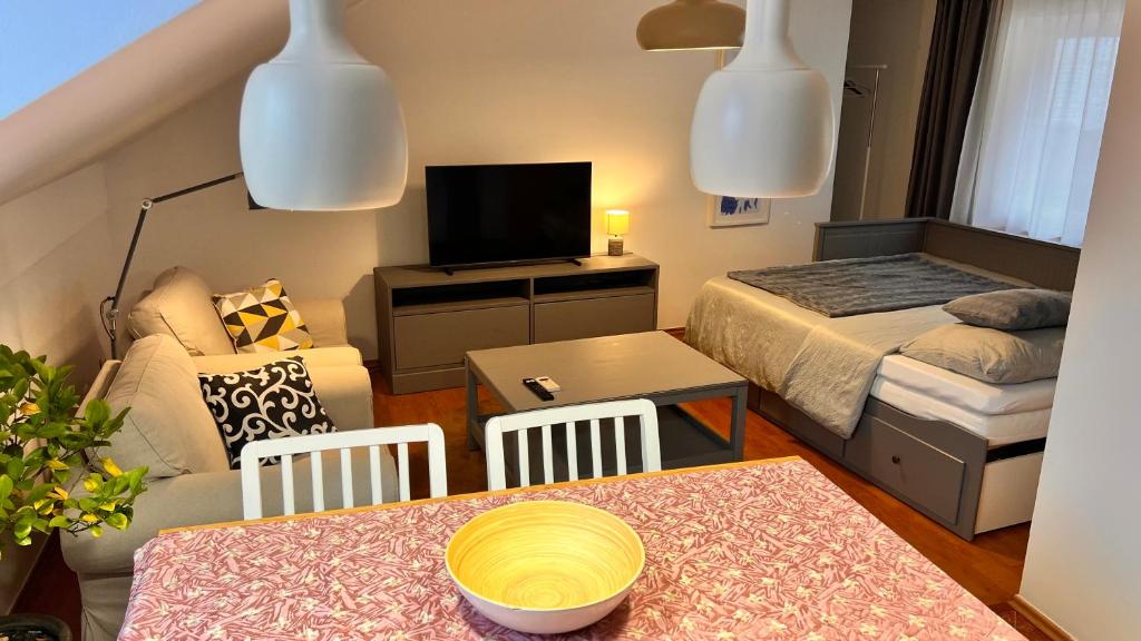 a small living room with a bed and a table at Samobor Old Town Studio by the River in Samobor