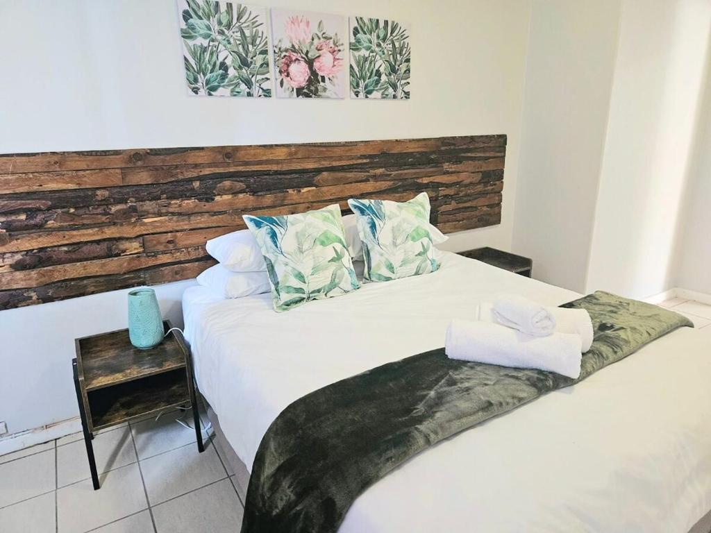 a bedroom with two beds with towels on them at Sea Breeze Manor - Sage Unit in East London