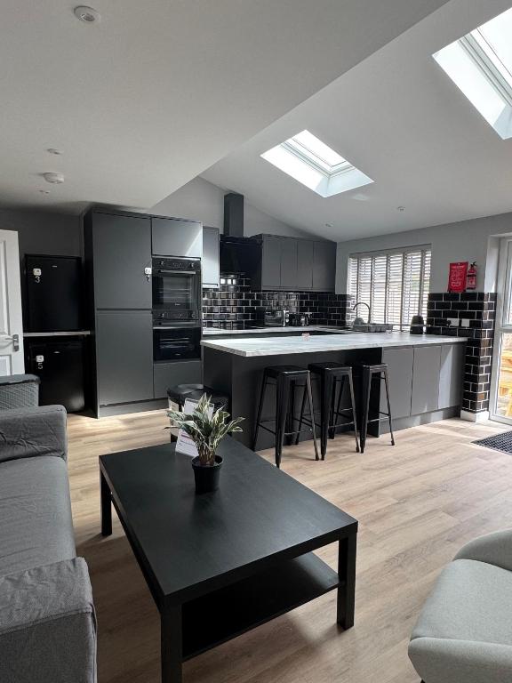 a large kitchen with a black table in a room at Ravenscourt House in Bristol