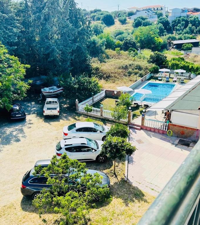 a group of cars parked in a parking lot at Apartments Spartacus in Polychrono