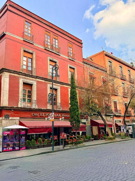 a large red building on a city street at Hotel Zamora Downtown CDMX in Mexico City