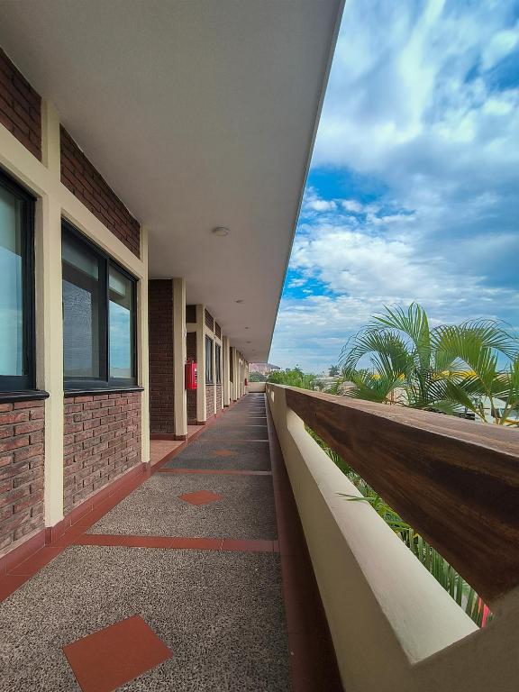 a hallway of a building with a walk way at Hotel la Palapa Mazatlan in Mazatlán
