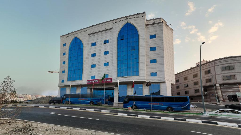 a blue bus parked in front of a building at Maidan Al Bait in Mecca
