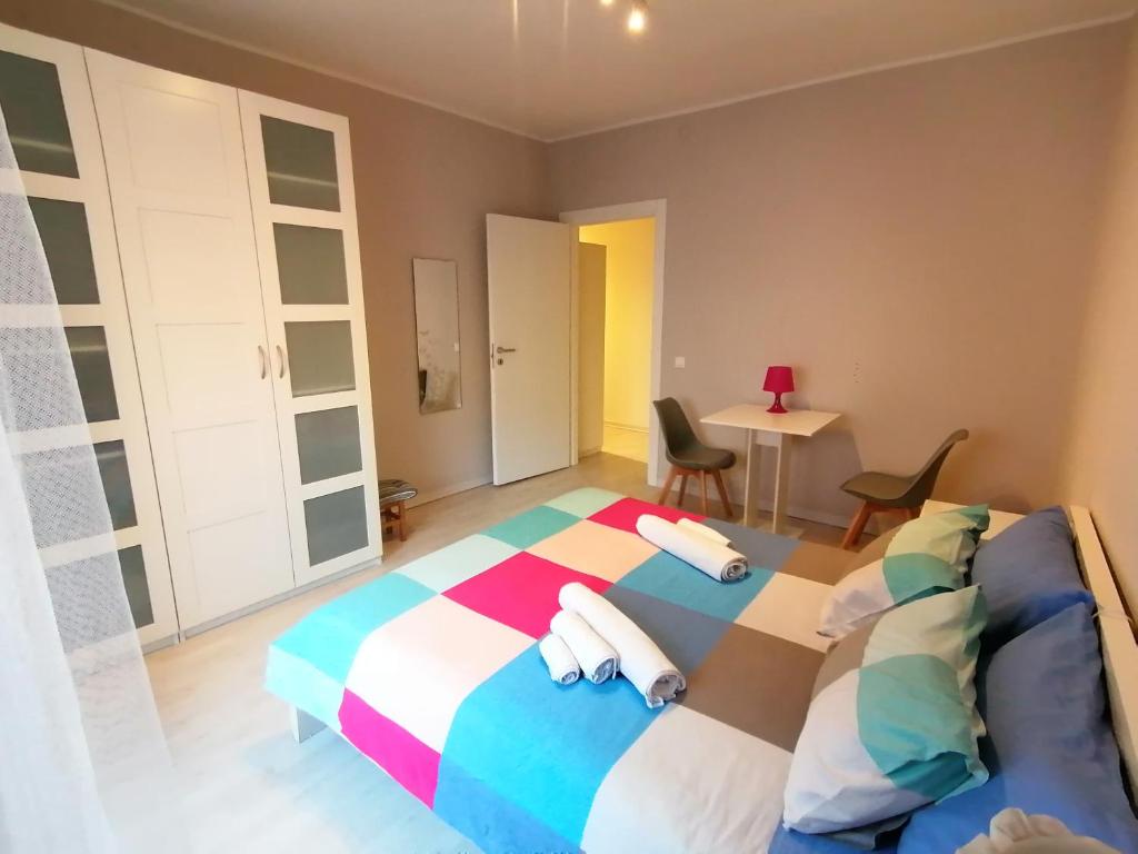 a bedroom with a bed and a table and chairs at Frank's studio rooms in Padova