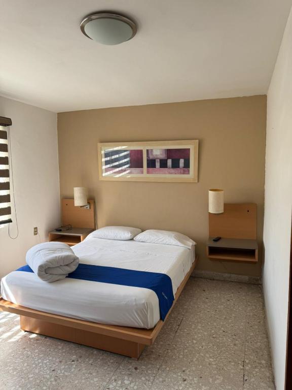 a bedroom with two beds and a window at Hotel Queretaro in Querétaro