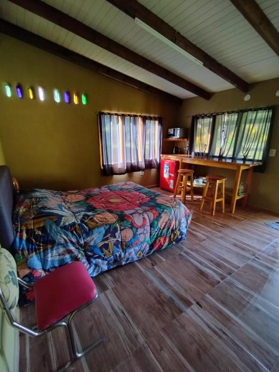 a bedroom with a bed and a table and chairs at Casa Terra Monoambiente in El Bolsón