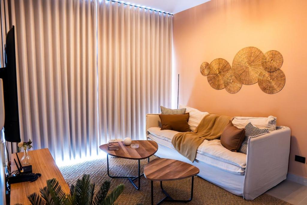 a living room with a white couch and a table at Punta Cana with Private Jacuzzi in Punta Cana